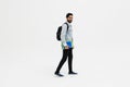 Young student indian man smiling, looking at camera and holding books walk isolated on white background Royalty Free Stock Photo