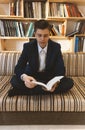 Young student learning in front of bright window