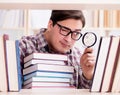 Young student looking for books in college library Royalty Free Stock Photo