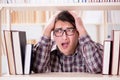 The young student looking for books in college library Royalty Free Stock Photo