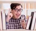 Young student looking for books in college library Royalty Free Stock Photo