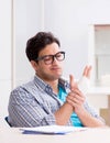 Young student man with hand injury preparing for the exams Royalty Free Stock Photo