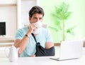 Young student man with neck and hand injury at home Royalty Free Stock Photo