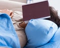 Young student man preparing for college exams in bed with book Royalty Free Stock Photo