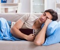 Young student man preparing for college exams in bed with book Royalty Free Stock Photo