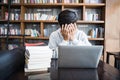 Young student man tired of computer sitting at cafe table