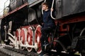 Young student man wait on Old Steam Train. future engineer technologist