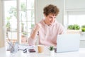 Young student man working and studying using computer laptop screaming proud and celebrating victory and success very excited, Royalty Free Stock Photo