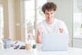 Young student man working and studying using computer laptop screaming proud and celebrating victory and success very excited, Royalty Free Stock Photo