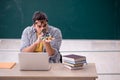 Young male student physicist sitting in the classroom