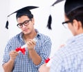 Young student planning graduation speech in front of mirror