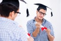 The young student planning graduation speech in front of mirror