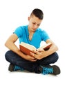 Young student reading a book on the floor