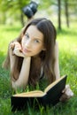 Young student reading book meadow Royalty Free Stock Photo