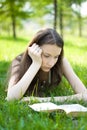 Young student reading book in park Royalty Free Stock Photo