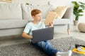 Young student redhead boy with laptop doing homework at home Royalty Free Stock Photo