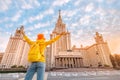 Young student rejoices of the beginning of the school year in front of the main building of Lomonosov Moscow State University