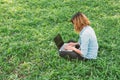 Young student relax in the park. work with laptop in green grass Royalty Free Stock Photo