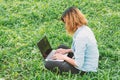 Young student relax in the park. work with laptop in green grass Royalty Free Stock Photo
