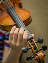 Young student`s hands practicing the violin