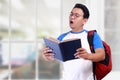 Young Student Shocked when Reading a Book