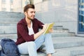 Young student making notes sitting on stairs Royalty Free Stock Photo