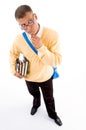 Young student standing with books and bag thinking Royalty Free Stock Photo