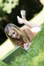 Young student surfing the internet in a park Royalty Free Stock Photo