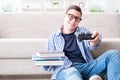 The young student trying to balance studying and playing games Royalty Free Stock Photo