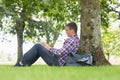 Young student using his laptop to study outside Royalty Free Stock Photo