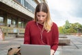 Young student using laptop outdoors Royalty Free Stock Photo