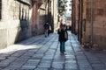 Young student walking by old street of Salamanca near University