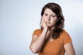 Young student woman with a aching tooth, copy space on empty background