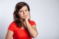 Young student woman with a aching tooth, copy space on empty background