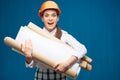 Young student woman architect holding paper plans, blueprints