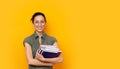 Young student woman smiling holding books and wearing Royalty Free Stock Photo