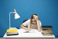 Young student woman in white casual clothes reading the book in library of university or college. Sitting and reading on Royalty Free Stock Photo