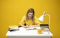 Young student woman in yellow casual clothes reading the book in library of university or college. Sitting and reading Royalty Free Stock Photo