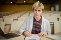 Young Student Writing Notes During Lecture Royalty Free Stock Photo