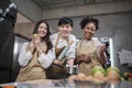 Young students in cooking class smiling, learning fun culinary courses together Royalty Free Stock Photo