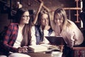 Young students girls in cafe learning together. Royalty Free Stock Photo