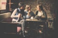 Young students girls sitting in cafe and learning togeth Royalty Free Stock Photo