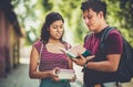 Young students standing on street with books and talking Royalty Free Stock Photo