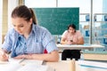 The young students taking the math exam in classroom