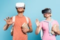Students in virtual reality headsets holding