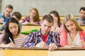 Young students writing notes in the classroom Royalty Free Stock Photo