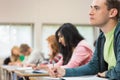 Young students writing notes in classroom Royalty Free Stock Photo