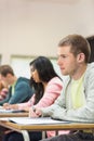 Young students writing notes in classroom Royalty Free Stock Photo