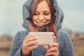 Young style girl making selfie with mobile phone in a park.