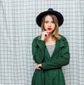 Young style woman in hat and green cloak in 90s style